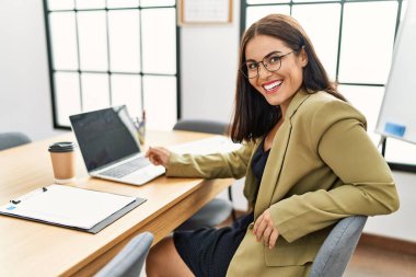 Young beautiful hispanic woman business worker using laptop working at office