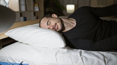 Hispanik bir adam karanlık bir odada huzur içinde uyuyor, rahatlama ve rahatlama hissi veriyor..