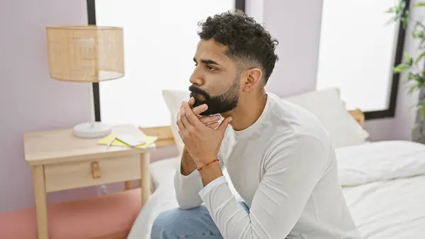 Thoughtful Bearded Man Sitting Bed Bedroom Looking Contemplative Wearing White — Stock Photo, Image