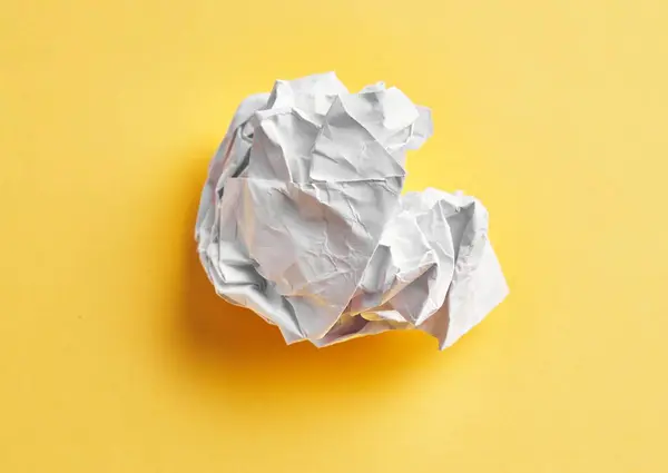 One White Crumpled Paper Ball Isolated Yellow Background — Stok fotoğraf