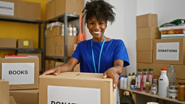 African american woman volunteer smiling confident standing at charity center