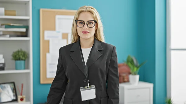 Young blonde woman business worker smiling confident at the office