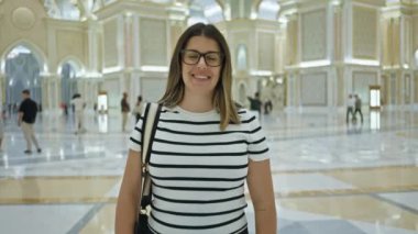 Abu Dabi 'deki süslü Qasr al Watan Sarayı' nda gözlüklü gülümseyen kadın..