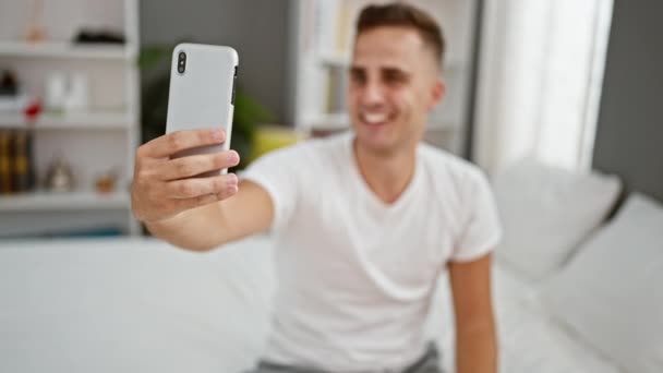 Joven Adulto Sonriente Toma Una Selfie Ambiente Ordenado Dormitorio Retratando — Vídeo de stock