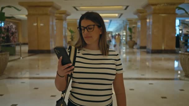Stylish Woman Striped Shirt Takes Selfie Luxurious Hotel Lobby Portraying — Stock Video