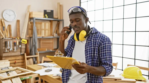 African American Man Phone Carpentry Workshop Looking Clipboard — Stock Photo, Image
