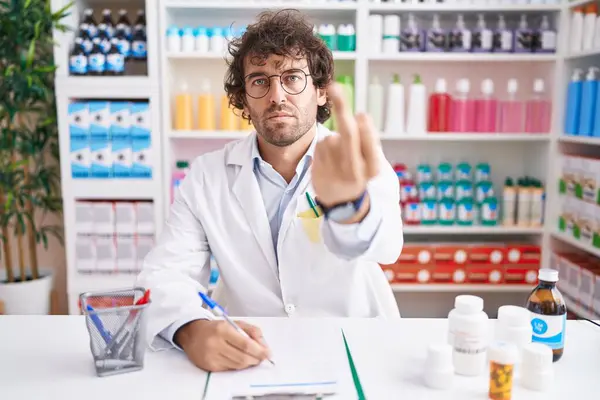 Hispanic Young Man Working Pharmacy Drugstore Showing Middle Finger Impolite — Stockfoto