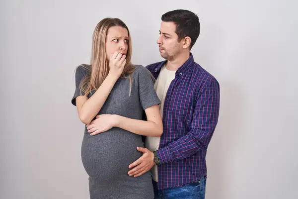 Young Couple Expecting Baby Standing White Background Looking Stressed Nervous — Stock Photo, Image