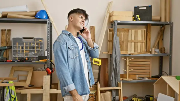 Smiling Young Hispanic Carpenter Confidently Talking Business Smartphone Bustling Carpentry — Stock Photo, Image