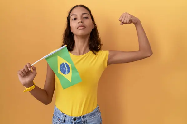 Young Hispanic Woman Holding Brazil Flag Strong Person Showing Arm — Stock Photo, Image
