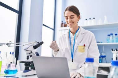 Young caucasian woman scientist having video call at laboratory