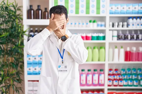 Handsome Hispanic Man Working Pharmacy Drugstore Covering Eyes Mouth Hands — Stock Photo, Image