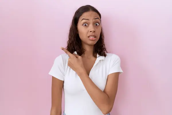 Young Hispanic Woman Wearing Casual White Shirt Pointing Aside Worried — Stock Photo, Image
