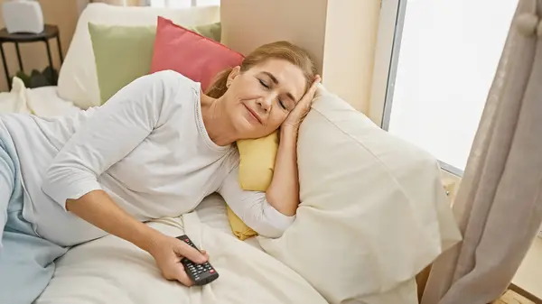 Mature Caucasian Woman Relaxing Bedroom Remote — Stock Photo, Image