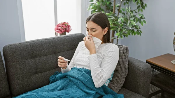Hispanic Woman Feeling Sick Home Holding Thermometer Sneezing Tissue While — Stock Photo, Image