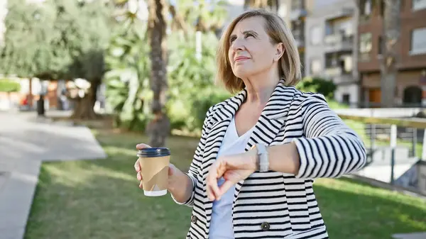 Mature Woman Checking Time Outdoors While Holding Coffee Greenery City — Stock Photo, Image