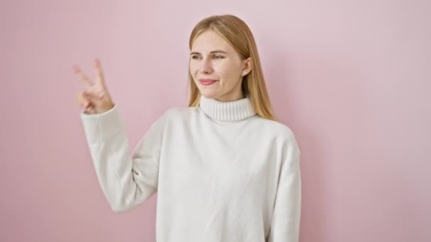 Cheerful Beautiful Blonde Girl Expressing Positivity While Showing Peace Sign — Stock Video