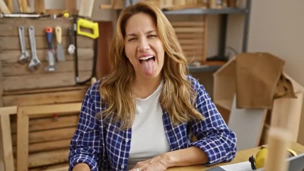Happy Latin Woman Having Fun Carpentry Sitting Table Playful Tongue — Stock Video