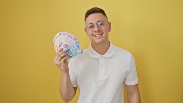 Cheerful Young Hispanic Man Confidently Holding Mexican Peso Banknotes Gesturing — Stock Video