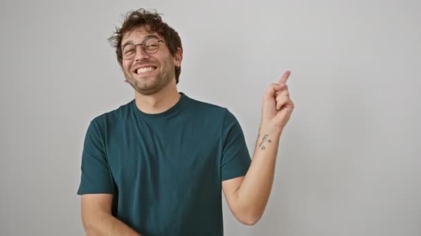 Cheerful Young Hispanic Man Glasses Joyfully Pointing Sideways Confident Smile — Stock Video