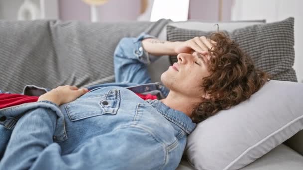 Young Man Curly Hair Lies Couch Home Looking Tired Unwell — Stock Video