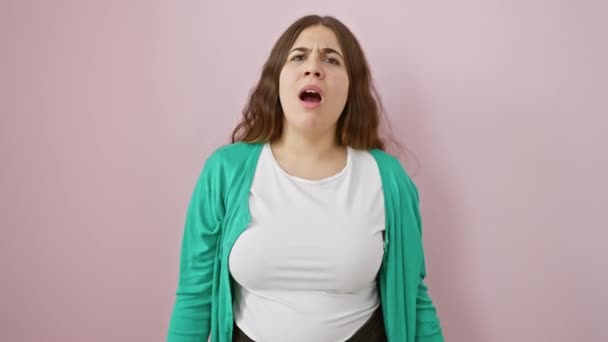 Skeptical Beautiful Young Hispanic Woman Open Mouth Standing Pink Isolated — Stock Video