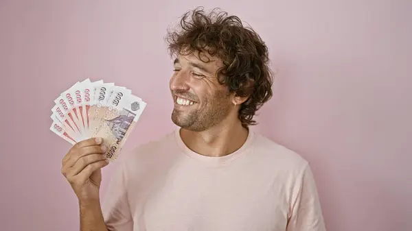 Cheerful Young Man Holding Icelandic Kronur Front Pink Background Portraying — Stock Photo, Image