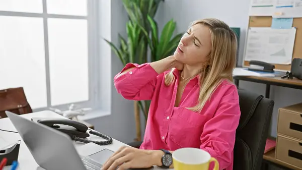 Young Woman Pink Shirt Expressing Discomfort Her Office Desk Suggesting — Stock Photo, Image