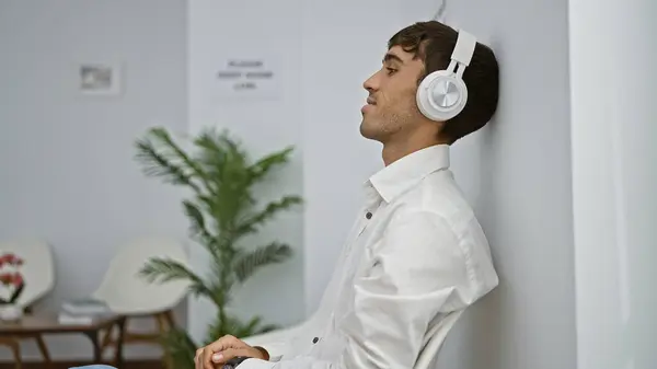 Homem Hispânico Confiante Todos Sorrisos Desfrutando Música Enquanto Espera Lobby — Fotografia de Stock