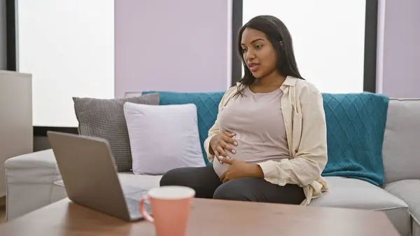 Expecting Young Hispanic Woman Comfortably Lounging Home Massaging Her Pregnant — Stock Photo, Image