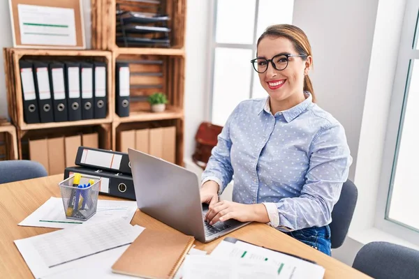 Young beautiful hispanic woman business worker using laptop working at office