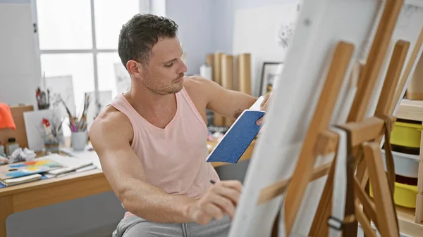 Focused Man Painting Canvas Bright Art Studio Showcasing Creativity Concentration — Stock Photo, Image