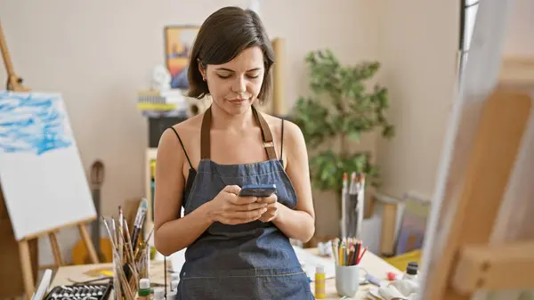 Young Beautiful Hispanic Woman Artist Stands Engrossed Smartphone Hand Art — Stock Photo, Image