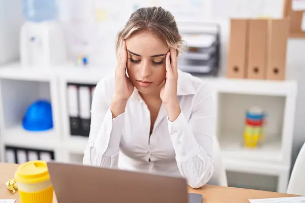 Young blonde woman business worker stressed using laptop at office