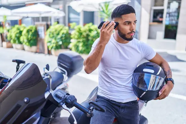 Young Latin Man Listening Voice Message Smartphone Sitting Motorbike Street — Stockfoto