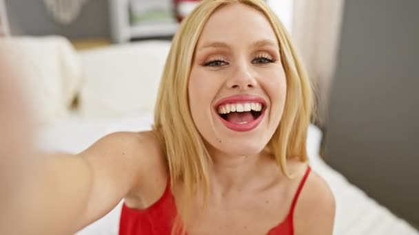 Cheerful Young Blonde Woman Takes Selfie Cozy Bedroom Setting Exuding — Stock Video