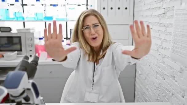 Frustrated Middle Age Blonde Woman Scientist Sitting Lab Angrily Gesturing — Stock Video