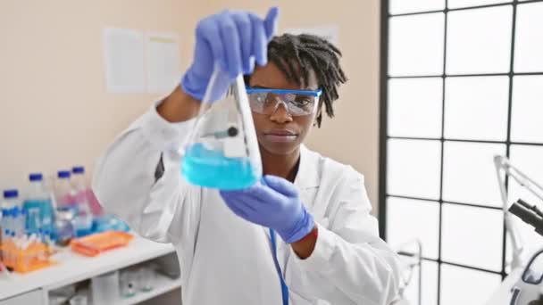 African Woman Scientist Analyzing Blue Liquid Flask Laboratory — Stock Video