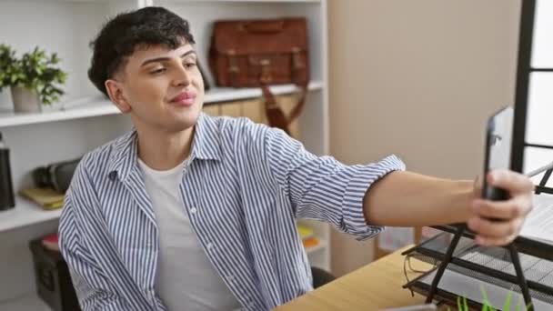 Smiling Young Man Takes Selfie Modern Office Setting Showcasing Casual — Stock Video