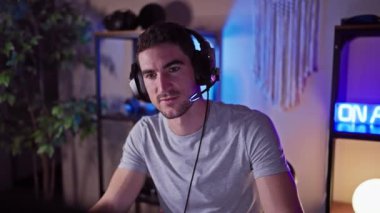 Oyun odasında kulaklığı olan genç bir İspanyol adam kameraya bakıyor ve geceleri heyecanını ve başarısını anlatıyor..