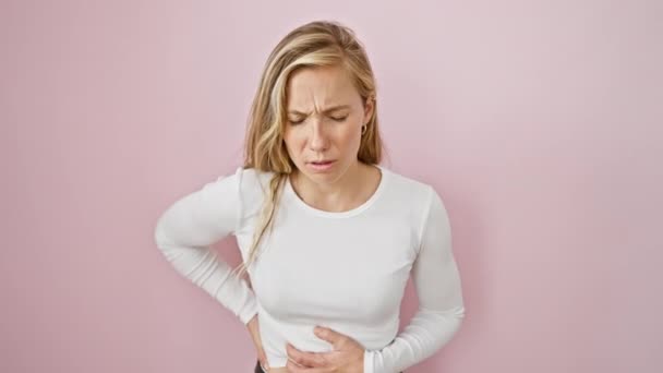 Young Blonde Woman Doubled Painful Stomachache Hand Clutching Belly Amidst — Stock Video