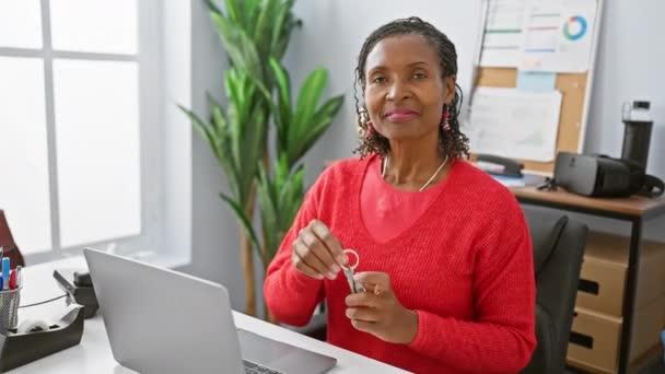 African American Woman Smiling Holding Keys Modern Office — Stock Video