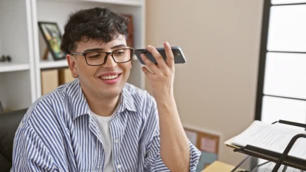 Young Man Glasses Holds Smartphone Smiling Sends Voice Message His — Stock Video