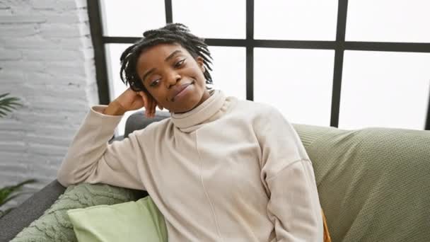 Confident Smiling Young Black Woman Dreadlocks Relaxing Home Sofa Positively — Stock Video