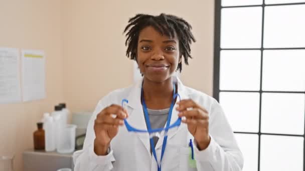 Smiling Young African American Woman Scientist Dreadlocks Dons Safety Goggles — Stock Video