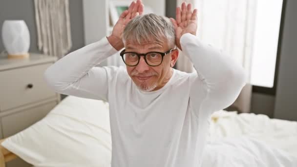 Skeptical Middle Aged Grey Haired Man Pyjamas Pulling Cynical Bunny — Stock Video
