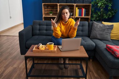 Young beautiful plus size woman having breakfast doing yoga exercise at home