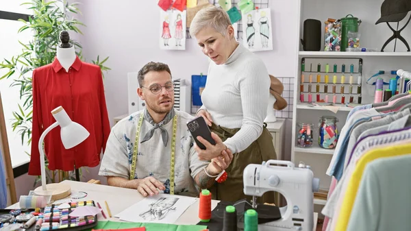 Two Tailors Man Woman Examine Smartphone Bright Organized Tailor Shop — Stock Photo, Image
