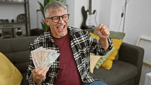 Excited Middle Aged Man Holding British Pounds Celebrates Indoors Guitar — Stock Photo, Image