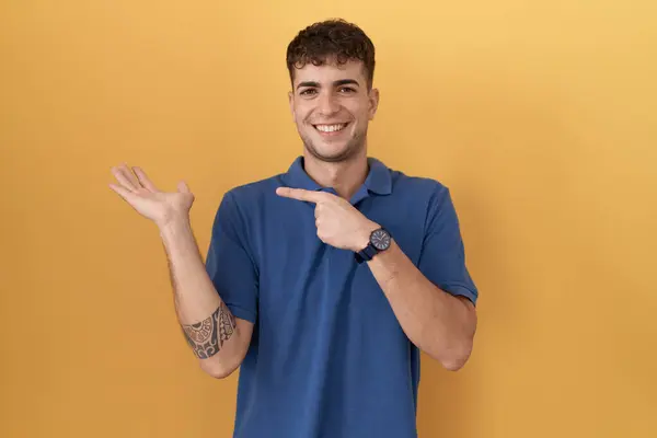 Young Hispanic Man Standing Yellow Background Amazed Smiling Camera While — Stock fotografie